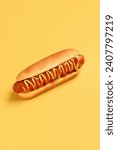 Tasty hot dog with mustard and ketchup on yellow background