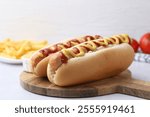 Tasty hot dogs served on light table, closeup