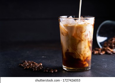 Tasty Ice Coffee With Milk , Cold Drink In Glass On Dark Background Copy Space