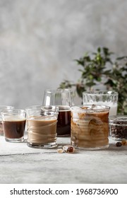 Tasty ice coffee with milk, cream and set with different types of coffee drinkson gray background with copy space. Ice coffee with milk, espresso, cappuccino and mocha coffee. Cold summer drink.