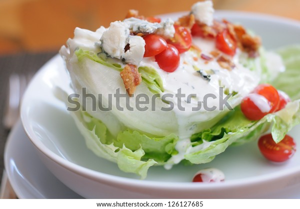 Tasty Iceberg Lettuce Wedge, Topped with Tomatoes,\
Blue Cheese and Bacon