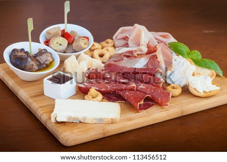 Similar – Image, Stock Photo Cheese Board with Ham, Cheese and a Knife