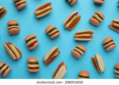 Tasty Jelly Candies In Shape Of Burger And Hot Dog On Light Blue Background, Flat Lay