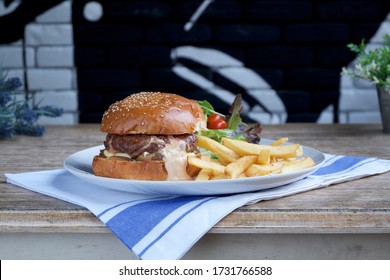 Tasty Juicy Lucy Burger On Wooden Table.