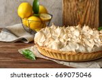 Tasty lemon meringue pie on wooden table, closeup
