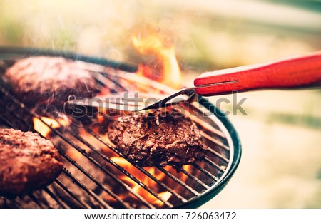 Tasty meat on the grill outdoors, preparing barbecue pork for burgers, traditional summer food cookout, good food for party outdoor