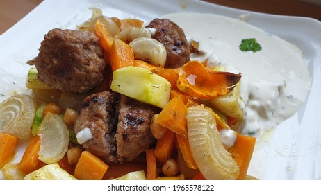 Tasty meatballs and vegetables lunch with white sauce on the side