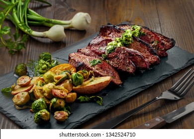 Tasty Pan-Seared Hanger Steak With Brussels Sprouts, Potatoes And Onion Meal Ona  Table. Healthy Home-made Food.