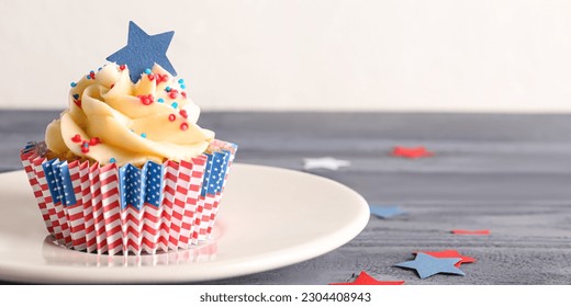 Tasty patriotic cupcake on wooden table. American Independence Day - Powered by Shutterstock