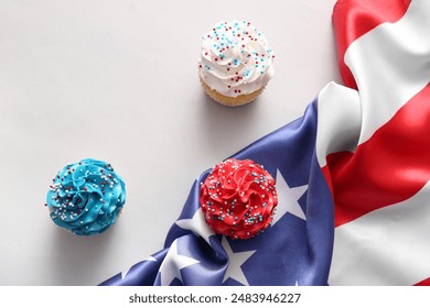 Tasty patriotic cupcakes with USA flag on grey background. American Independence Day - Powered by Shutterstock