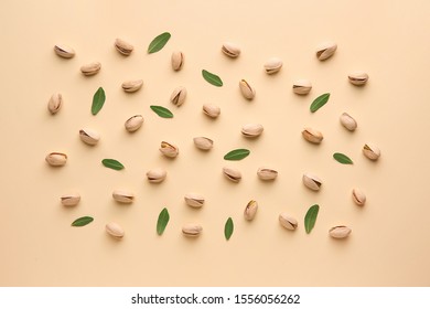 Tasty Pistachio Nuts On Color Background