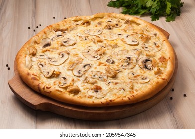tasty pizza with chicken and mushrooms on a wooden board - Powered by Shutterstock