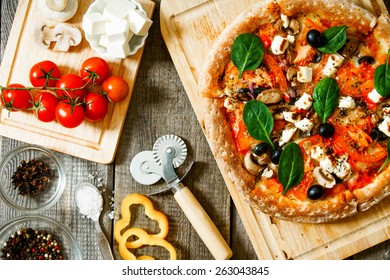 Tasty pizza on a wooden board. Veggie a pizza with ingridients . - Powered by Shutterstock