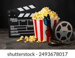 Tasty popcorn in buckets and cold cola drinks with cinema tickets, movie clapper and 3D eyeglasses on a bright colored background. Cinema concept. Watching a movie.Place for text. Copy space