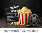 Tasty popcorn in buckets and cold cola drinks with cinema tickets, movie clapper and 3D eyeglasses on a bright colored background. Cinema concept. Watching a movie.Place for text. Copy space