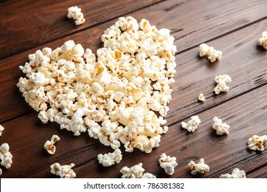 Tasty popcorn on wooden background