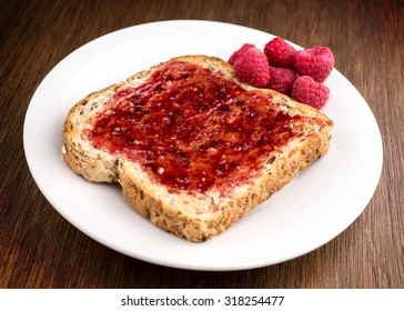 Tasty Rasberry Jam Spread On Whole Wheat Toast