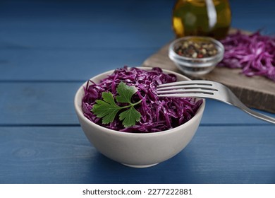 Tasty red cabbage sauerkraut with parsley on light blue wooden table - Powered by Shutterstock