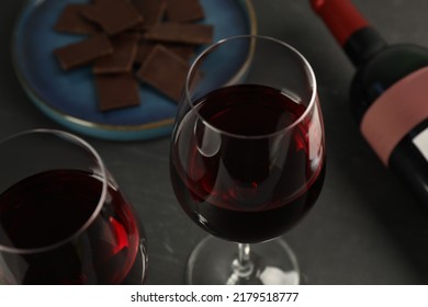 Tasty Red Wine And Chocolate On Black Table, Closeup