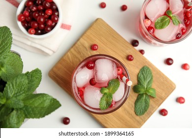 Tasty Refreshing Cranberry Cocktail With Mint On White Table, Flat Lay