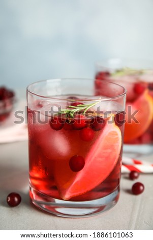 Tasty refreshing cranberry cocktail on light grey table
