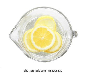 Tasty refreshing lemonade in glass jug on white background