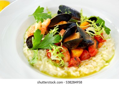Tasty risotto with seafood mussel and shrimp on white plate