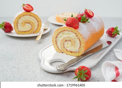 Tasty roll cake stuffed with cream cheese ,decorated with fresh strawberry - Powered by Shutterstock