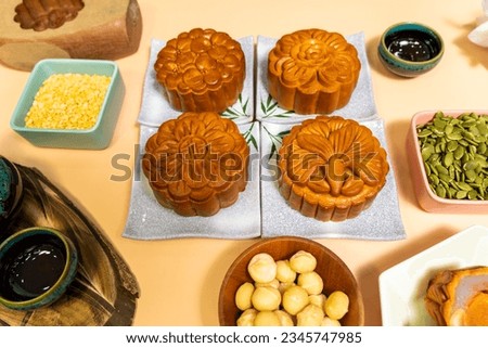 a tasty round moon cakes at mid autumn festival. Flat lay mid autumn festival food and drink on sweet beige background. Travel, holiday, food concept