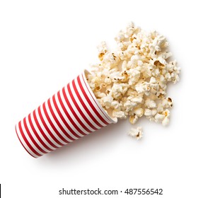 Tasty salted popcorn in striped paper cup isolated on white background.