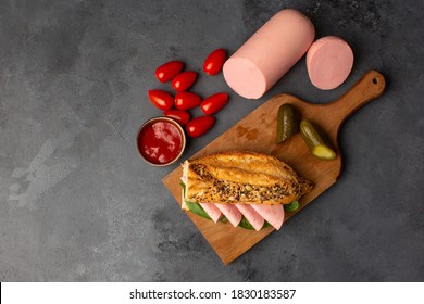 Tasty Sandwich In Baguette With Ham, Sausage And Salami