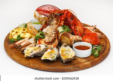 Tasty Seafood On Wooden Board Isolated On White