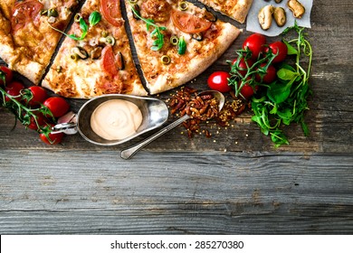 Tasty seafood pizza with cherries on a wooden table - Shutterstock ID 285270380