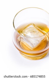 Tasty Single Malt Scotch Whiskey Served With A Large Ice Cube Isolated On A White Background