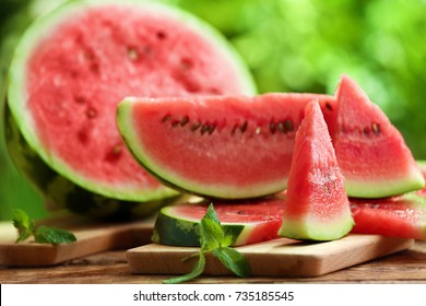 Tasty sliced watermelon on table outdoors