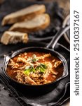 Tasty soup or stew made of beef tripe and spices. Spicy and aromatic tripe soup seasoned with pepper and served with bread.