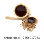 Tasty soy sauce in bowl, soybeans and spoon isolated on white, top view