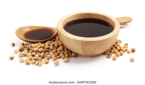 Tasty soy sauce in bowl, soybeans and spoon isolated on white