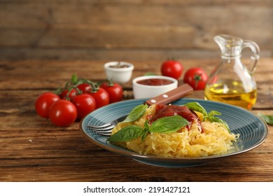 Tasty Spaghetti Squash With Tomato Sauce And Basil Served On Wooden Table