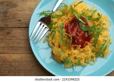 Tasty Spaghetti Squash With Tomato Sauce And Arugula Served On Wooden Table, Top View