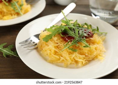 Tasty Spaghetti Squash With Tomato Sauce And Arugula Served On Wooden Table, Closeup