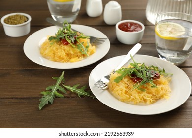 Tasty Spaghetti Squash With Tomato Sauce And Arugula Served On Wooden Table