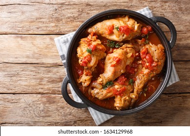 Tasty Spicy Rabbit Stew In Tomato Sauce With White Wine And Herbs Close-up In A Pan On The Table. Horizontal Top View From Above
