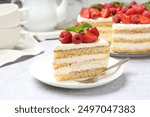 Tasty sponge cake with fresh berries and mint served on light gray table, closeup