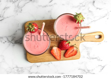 Similar – Image, Stock Photo Strawberry milkshake topped with whipped cream, minimalist on a green background