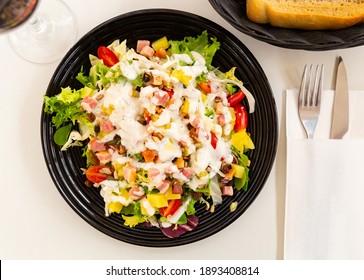 Tasty summer salad from mix of fresh herbs with tomatoes, juicy chunks of pineapple, toasted spiced pecans and pieces of bacon with creamy mayo dressing - Powered by Shutterstock