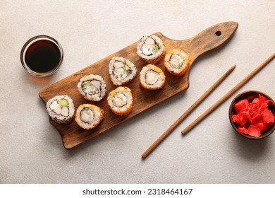 Tasty sushi rolls, soy sauce and ginger on light background - Powered by Shutterstock