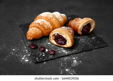 Tasty sweet croissants with jam on dark background - Shutterstock ID 1644019036