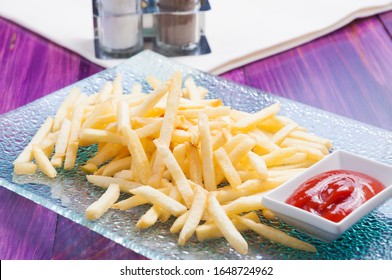 tasty thin French fries with tomato sauce