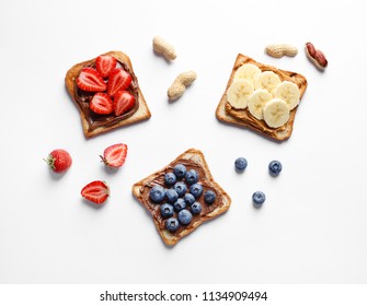 Tasty Toast Bread With Banana, Strawberry And Blueberry On White Background